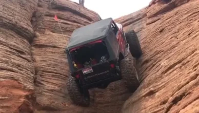 Jeep climbing up rock face
