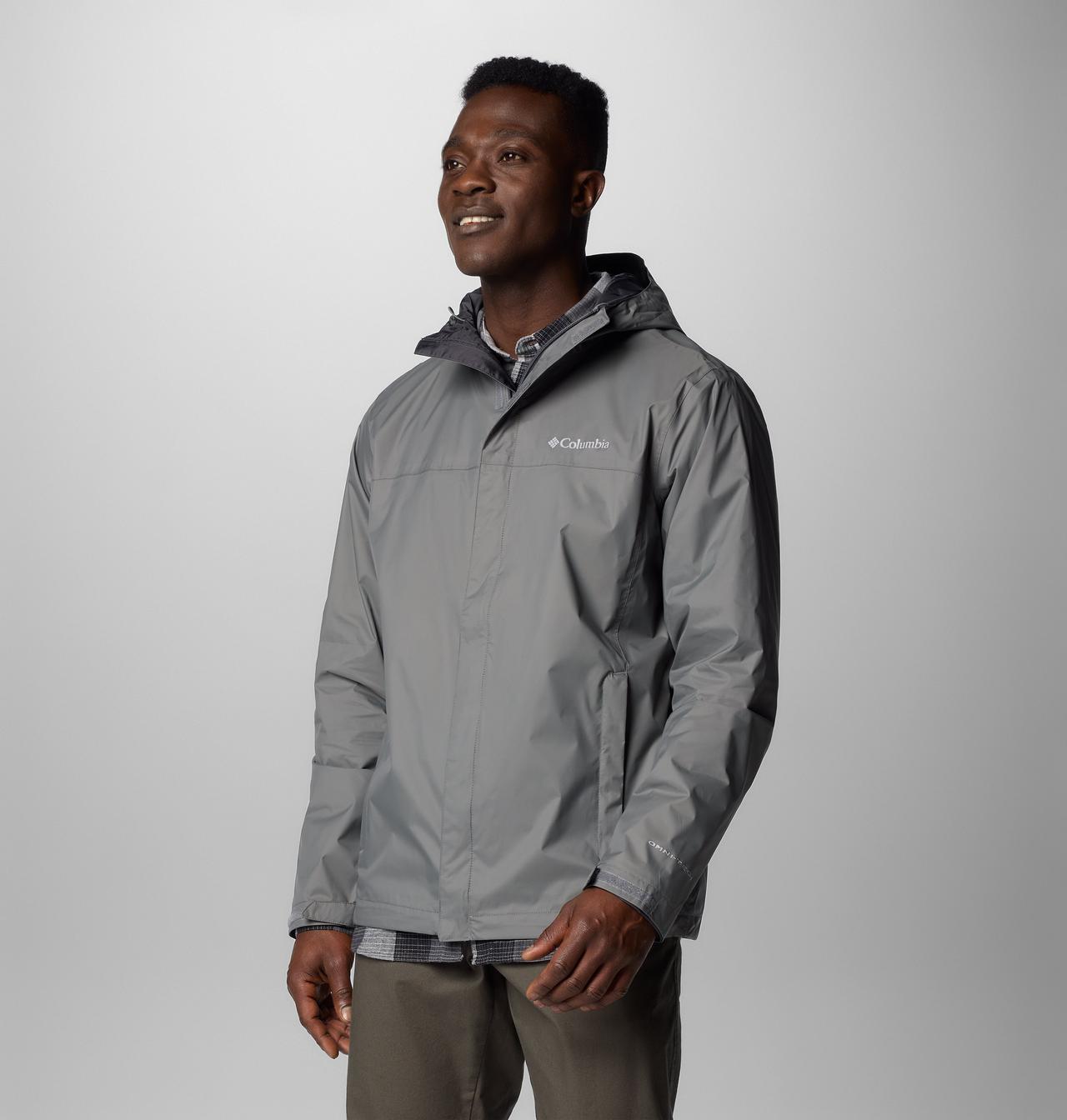 A model wearing the Columbia men's Watertight II hooded rain jacket in City Grey.