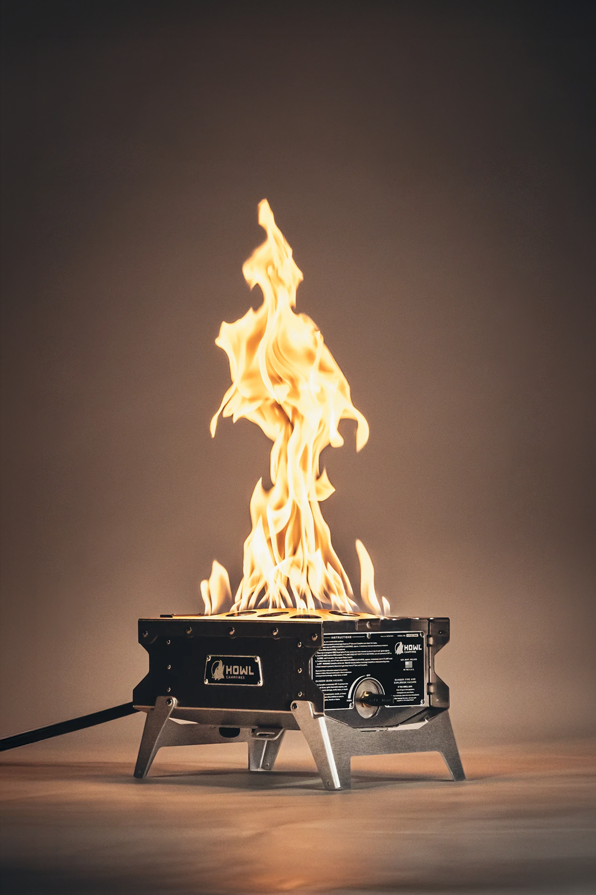 HOWL R1 portable propane fire pit with folding legs.